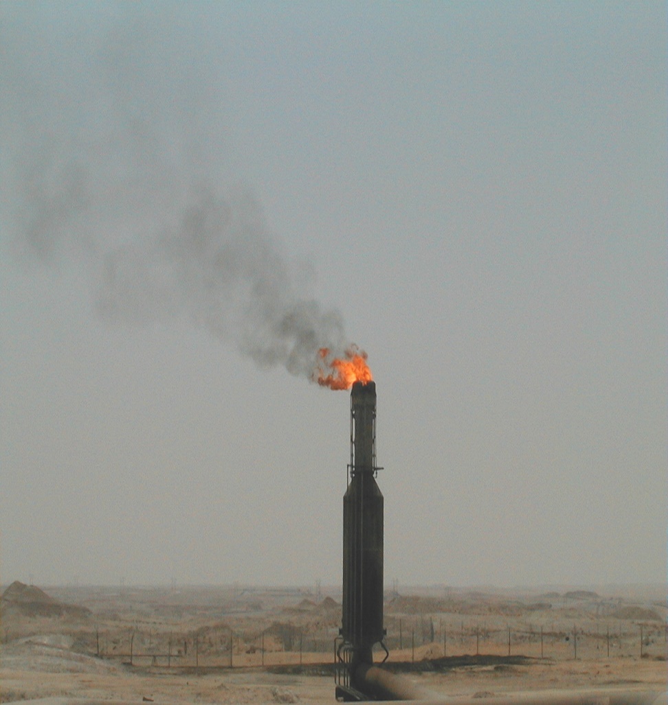 Flare stack before HP Air Assist — large orange flame with heavy black smoke, high-emission state